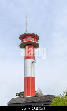Red and white lighthouse of Schausende in Schleswig-Holstein on a cloudy day Stock Photo