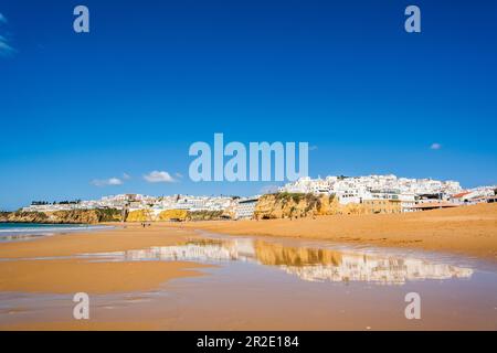 Great view of Fisherman Beach, Praia dos Pescadores, with whitewashed houses on cliff, reflecting on the sea, blue sky, summer time, Albufeira, Algarv Stock Photo