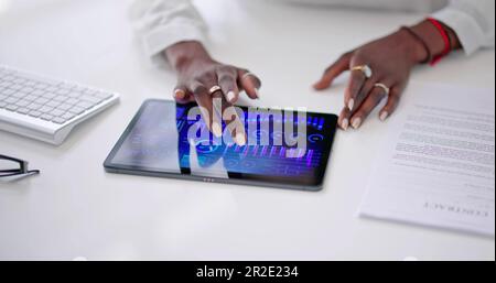 African American Data Analyst Using Data Analytics KPI Dashboard Stock Photo