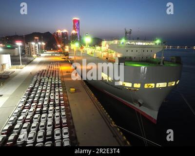 LIANYUNGANG, CHINA - MAY 19, 2023 - Ro-ro wheels load 1,700 cars for export to Mexico at Berth 58 of Lianyungang Terminal in East China's Jiangsu prov Stock Photo