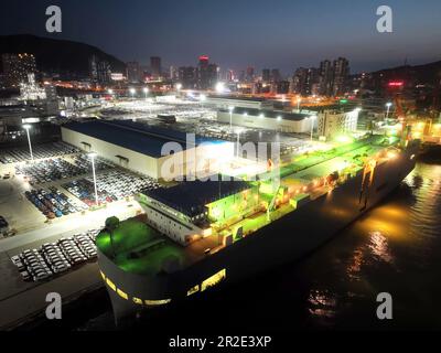 LIANYUNGANG, CHINA - MAY 19, 2023 - Ro-ro wheels load 1,700 cars for export to Mexico at Berth 58 of Lianyungang Terminal in East China's Jiangsu prov Stock Photo