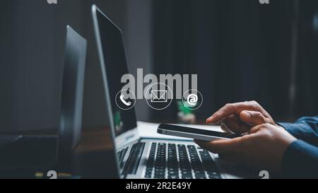 Customer support hotline contact us people connection concept. Web page online customer service technology idea. Businesswoman using smartphone with e Stock Photo