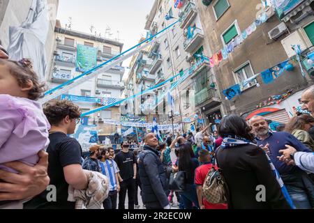 Naples, Italy - May 5, 2023: Fans of the Napoli football team celebrate the victory of the Italian championship in the street. Euphoric people flock to the Spanish quarters. Stock Photo