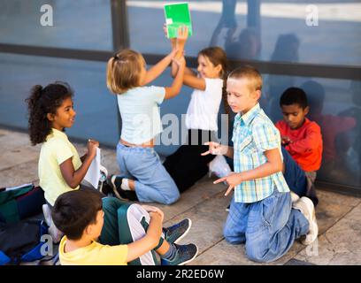 Group of children playing near school Stock Photo