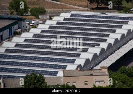 Electric power solar panels placed on the roof of an industrial warehouse. top view Stock Photo