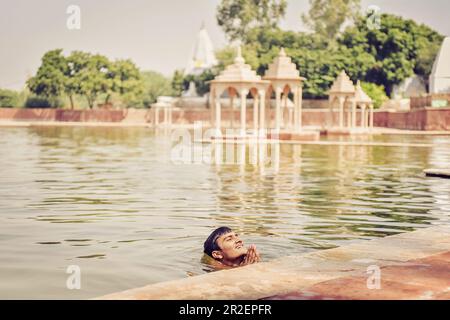 2017, Pavan Sarovar Nandgoan / Nandagram, Vrindavan, Uttar Pradesh, India, The Brahmin Krishna Murari Goswami having a bath in the holy seaside resort Stock Photo
