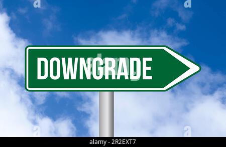 Downgrade road sign on sky background Stock Photo