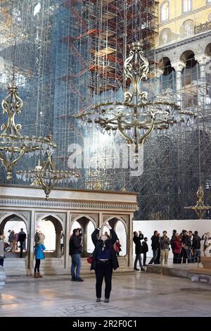 Tourists in Hagia Sophia with scaffolding in Istanbul, Turkey Stock Photo