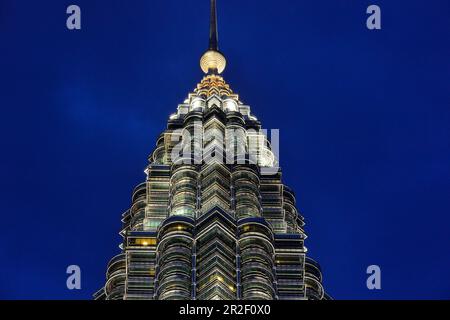 Partial view of the Petronas Towers in Kuala Lumpur, Malaysia, at the blue hour just before nightfall Stock Photo