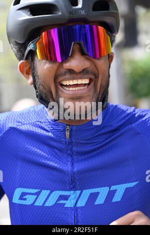 Male cyclist with sunglasses and helmet and cycling shirt portrait Stock Photo