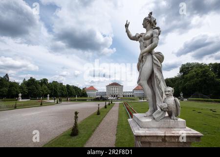 View of Nymphenburg Palace, in the foreground a statue from the Garden of the Gods, Munich, Bavaria, Germany, Europe Stock Photo