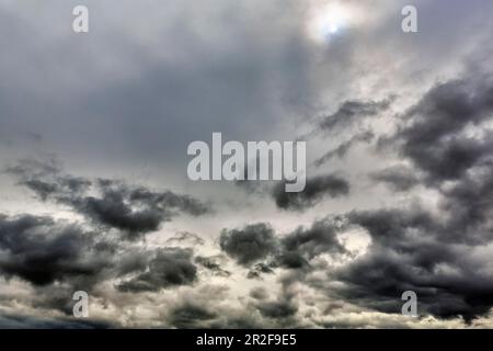 Sun shining through cloud cover, dark clouds, Ullapool, Scotland, Great Britain Stock Photo
