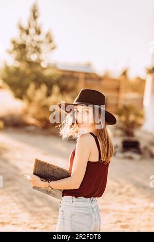 Woman reads book in Joshua Tree National Park, Joshua Tree, Los Angeles, California, USA, North America Stock Photo