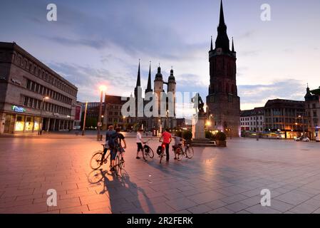 in the evening, market church with red tower on the market, cathedral, square, cyclists, tourists, Halle an der Saale, Saxony-Anhalt, Germany Stock Photo