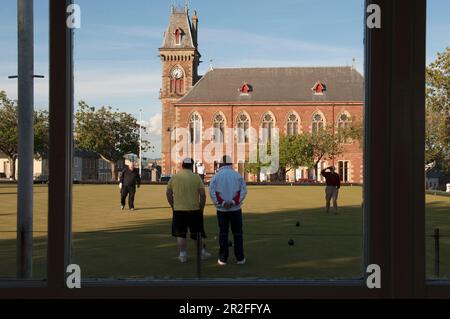 Bowls in play in front of the Wigtown County Buildings and Town Hall at the Wigtown lawn bowling club green in Wigtown; Dumfries; and Galloway, Scotla Stock Photo