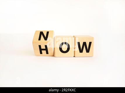 Know how symbol. Businessman turns wooden cubes and changes the word How to Know. Beautiful white table white background. Copy space. Business and kno Stock Photo