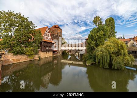 View from Maxbrücke to the Pegnitz (river) and the Henkerbrücke with water tower in the afternoon, Nuremberg city center, Franconia, Bavaria, Germany Stock Photo