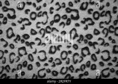 Soft fleecy faux fabric with a mottled pattern. Light leopard texture. Stock Photo