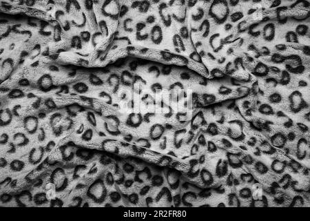 Soft fleecy faux fabric with a mottled pattern. Light leopard texture. Stock Photo