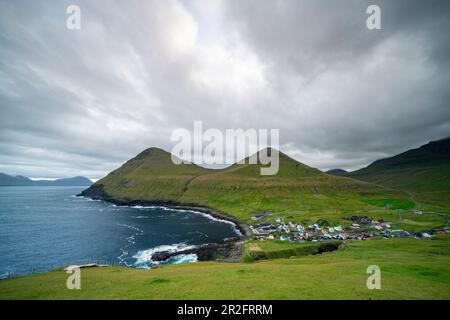 View from the steep coast to the sea and the mountains around Gjógv, Faroe Islands. Stock Photo