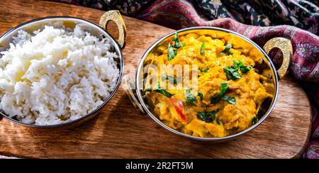 Curry chicken with rice served in original indian karahi pots Stock Photo