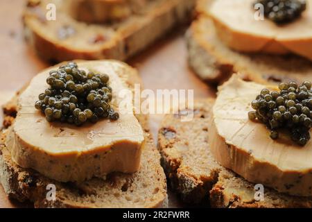 Sturgeon black caviar on foie gras and cutting bread, fevtive celebreation concept Stock Photo