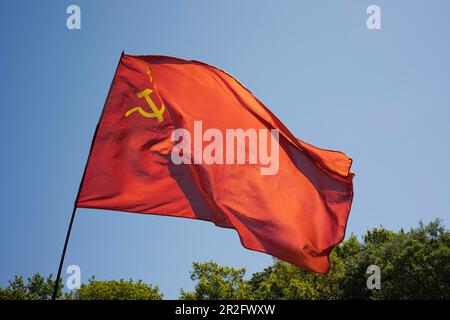 Russian national flag with hammer and sickle waving in the wind, Berlin, Germany Stock Photo