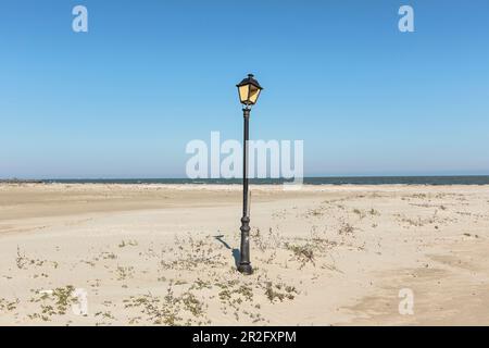 Black Sea coast at the mouth of the Danube / Danube Delta, lantern stands lonely and broken on the beach, Sulina, Tulcea, Romania. Stock Photo
