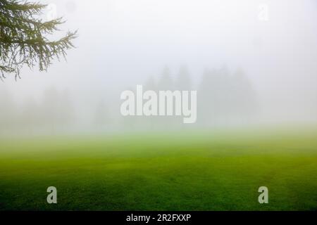 Crans Sur Sierre Golf Course with Fog in Crans Montana in Valais, Switzerland Stock Photo