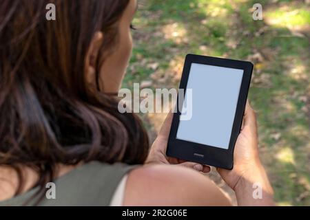 A modern black electronic book with a white blank empty screen. E-Book Reader and book mock up Stock Photo