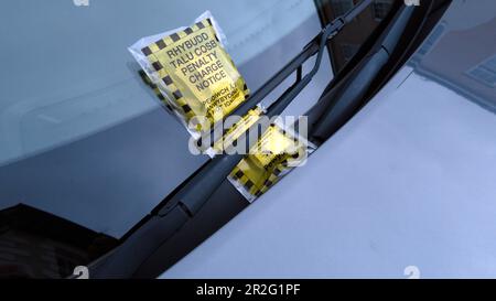 Bilingual penalty charge ticket for illegal car parking in the Wales UK. Stock Photo