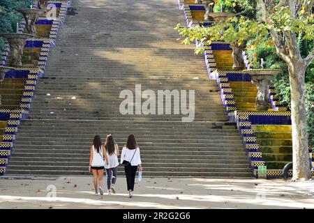 Three young women are walking in the park towards a staircase, Montjuic, Barcelona, Catalonia, Spain Stock Photo