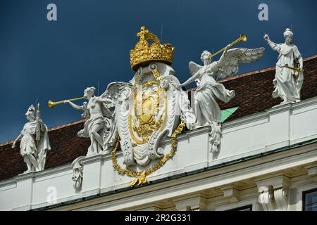 Angels and coats of arms as decoration of a historical roof on an Art Nouveau house, Vienna, Austria Stock Photo