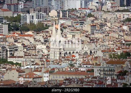 View from the Sanctuary of Notre-Dame-de-la-Garde over the rooftops of Marseille and the Church of St. Vincent de Paul, Marseille, Bouches-du-Rhone, P Stock Photo