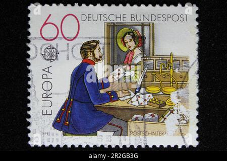 ISTANBUL, TURKEY - DECEMBER 25, 2020: German stamp shows Post Office window circa 1979 Stock Photo