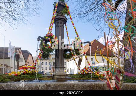 Easter fountain decorated with colorful Easter eggs and colored ribbons in Muggendorf in Franconian Switzerland, Bavaria, Germany Stock Photo