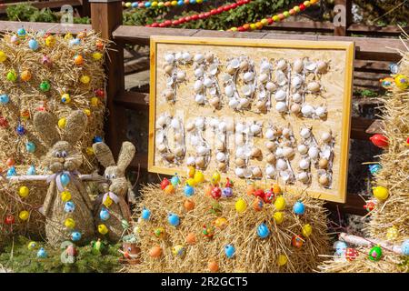 Happy Easter Chalkboard with egg shells at the Easter spring decorated with colorful Easter eggs at the Trubachquelle in Obertrubach in Franconian Swi Stock Photo