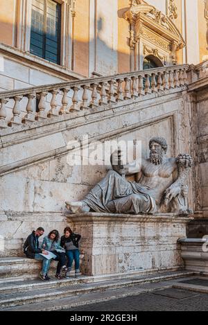 Tourists study map at Michelangelo's double staircase at the Senator's Palace today's City Hall, Rome, Lazio, Italy, Europe Stock Photo