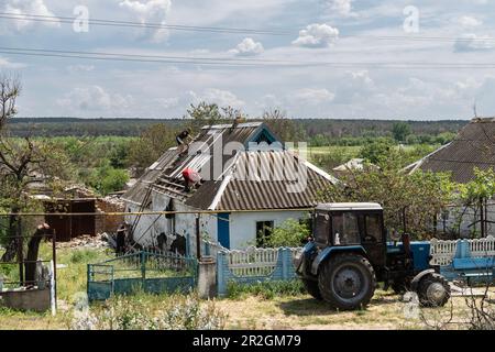 People seen rebuilding destroyed house of village Velyka Oleksandrivka of Kherson region on May 19, 2023 after liberation from Russian invasion Stock Photo