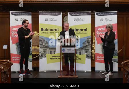 John Walsh Chief Executive of Belfast City Council speaking at Belfast City Hall during the Northern Ireland council elections with Newly elected Micky Murray (left) and Tara Brooks (right) from the Alliance Party. Picture date: Friday May 19, 2023. Stock Photo