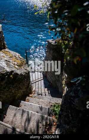 Metal Gate on the Waterfront with Sun Reflection in Lugano, Ticino, Switzerland. Stock Photo