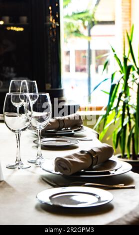 Vintage place setting for dinner in dark interior Stock Photo