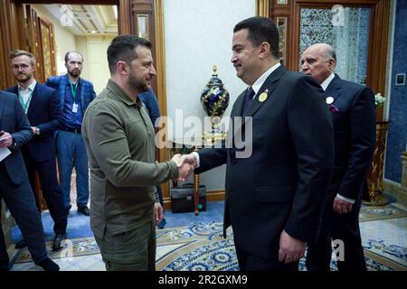 Jeddah, Saudi Arabia. 19th May, 2023. Ukrainian President Volodymyr Zelenskyy, left, shakes hands with Iraqi Prime Minister Mohammed Shiaa al-Sudani before their bilateral meeting on the sidelines of the Arab League Summit, May 19, 2023 in Jeddah, Saudi Arabia. Zelenskyy attended the annual summit meeting as part of a broader pitch for global support against the Russia invasion of Ukraine. Credit: Pool Photo/Ukrainian Presidential Press Office/Alamy Live News Stock Photo