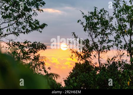 dramatic evening sky with sunset behind clouds on Príncipe Island in West Africa Stock Photo