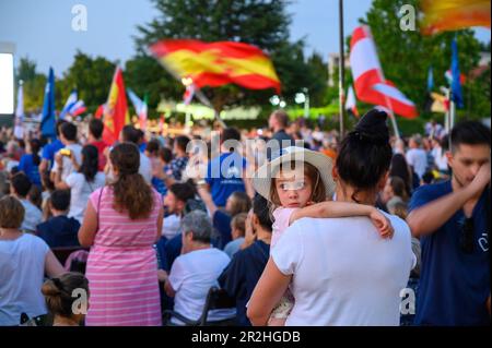 A little girl in mother's arms in a crowd of people. Holy Mass during Mladifest 2022 in Medjugorje. Stock Photo