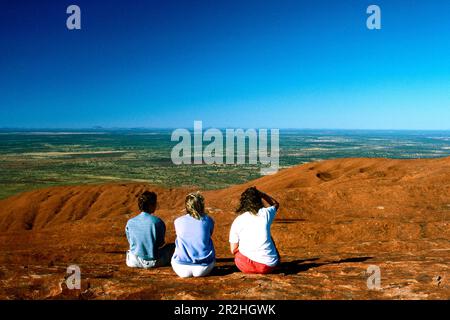 Hikers climbing Ayers Rock, Northern Territory, Australia Stock Photo