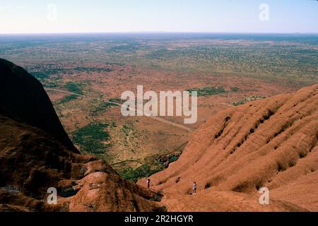 Hikers climbing Ayers Rock, Northern Territory, Australia Stock Photo