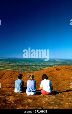 Hikers climbing Ayers Rock, Northern Territory, Australia Stock Photo