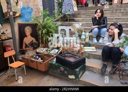 Beirut, Lebanon. 19th May, 2023. Exhibitors sit beside their stall at a flea market exhibition at St. Nicholas Stairs in Beirut, Lebanon, on May 19, 2023. The flea market exhibition is held here from May 19 to May 21. Credit: Liu Zongya/Xinhua/Alamy Live News Stock Photo