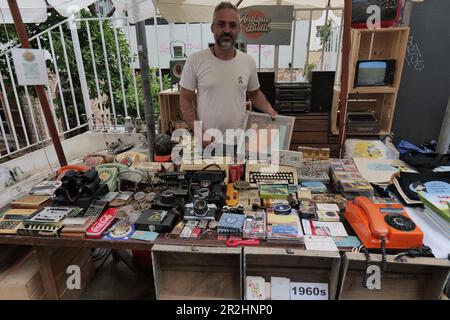 Beirut, Lebanon. 19th May, 2023. A man stands behind his stall at a flea market exhibition at St. Nicholas Stairs in Beirut, Lebanon, on May 19, 2023. The flea market exhibition is held here from May 19 to May 21. Credit: Dana Halawi/Xinhua/Alamy Live News Stock Photo